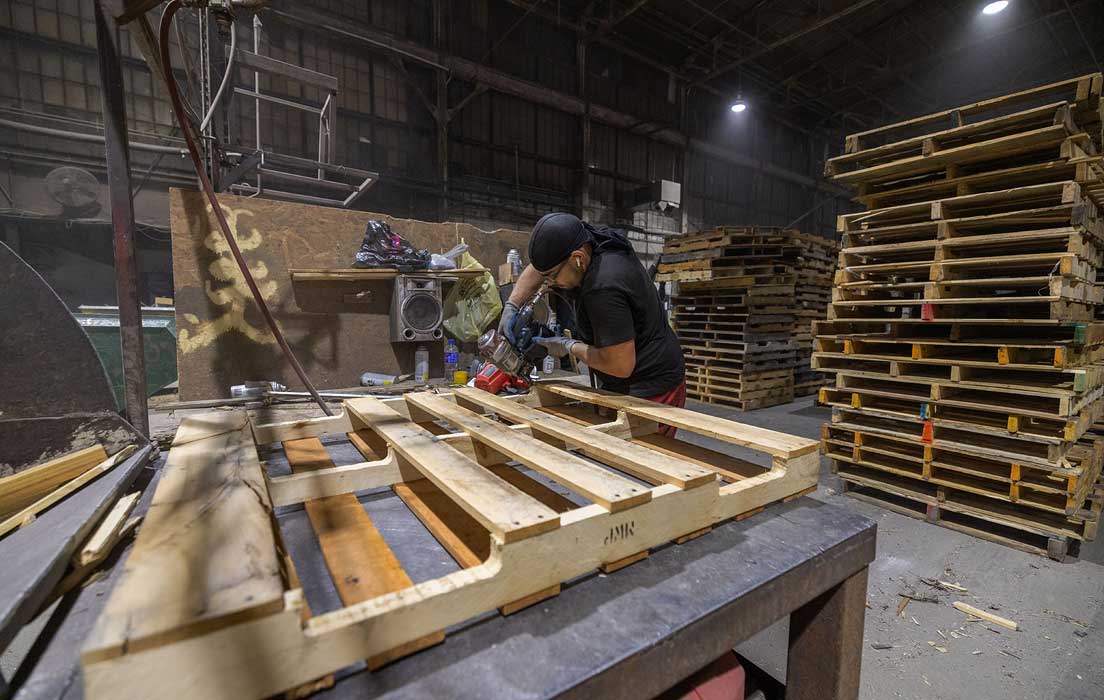 Image of man working on pallets at Iron City Wood Products